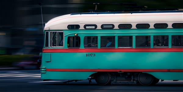 unethical blog photo Fast-moving teal and red trolley.