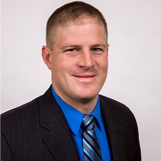 Man in suit smiling for camera.