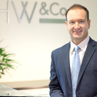 Man in suit smiling for camera.