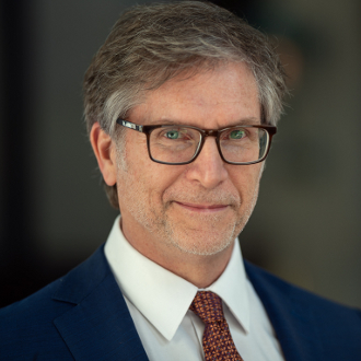 Man in suit smiling for camera.