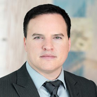 Man in suit looking at camera.