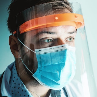 Man wearing face shield and mask.