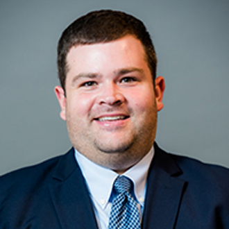 Man in suit smiling for camera.