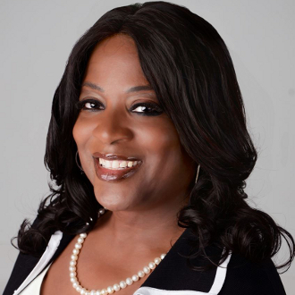 Professionally dressed woman smiling for camera.