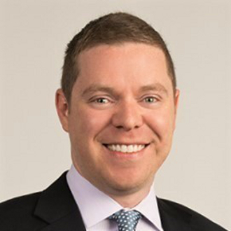 Man wearing suit and smiling for camera