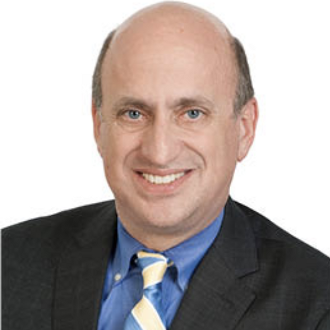 Man in suit smiling for camera.