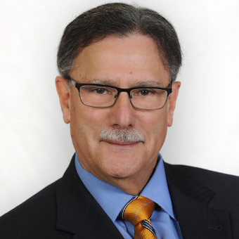 Man in suit smiling for camera.