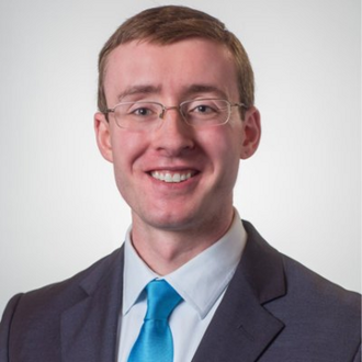 Man in suit smiling for camera.