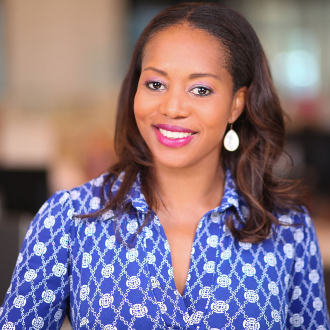 Professionally dressed woman smiling for camera.
