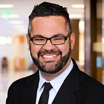 Man in suit smiling for camera.