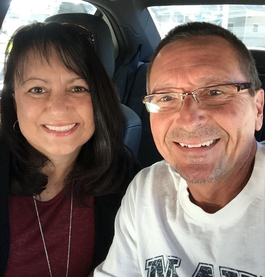 Woman and man smiling for the camera.